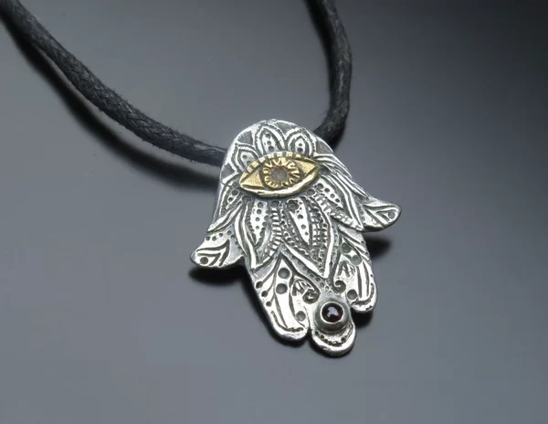 Hamsa silver pendant with garnet stone