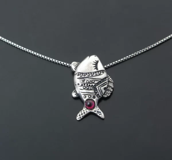 Silver fish with garnet stone pendant